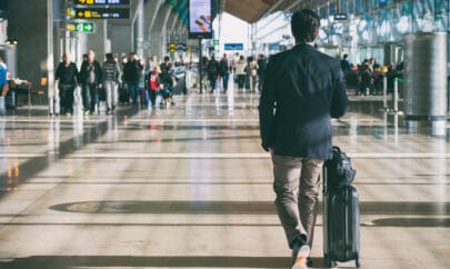 Close up of businessman carrying suitcase while walking through