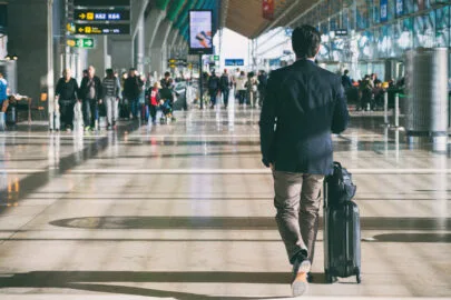 Close up of businessman carrying suitcase while walking through
